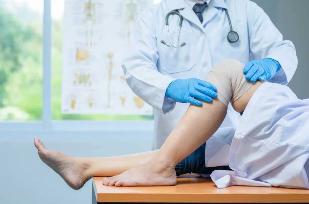 Doctor examining a patient's knee