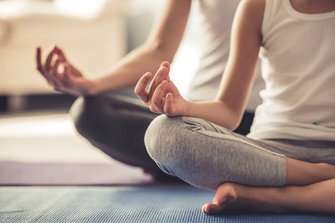 Person practising yoga on a mat